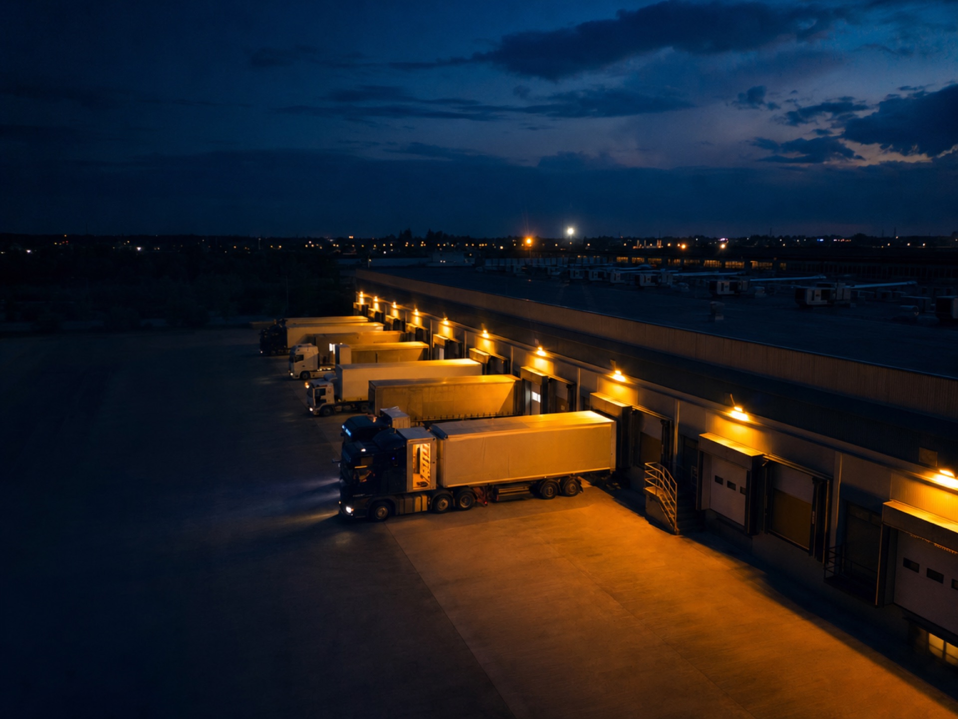 Logistics distribution hub at dusk — logistics software engagement